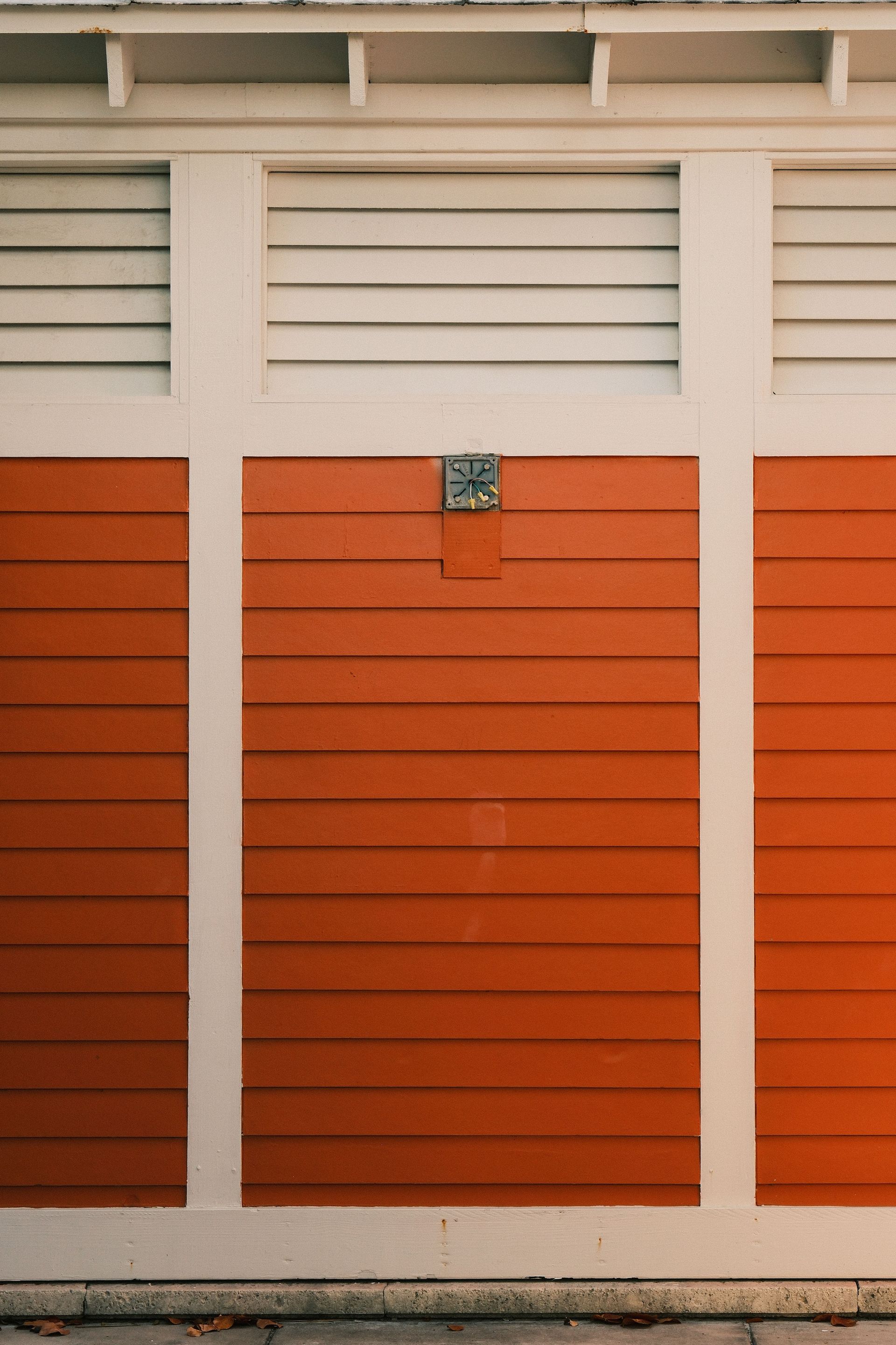 Bright red and white wooden facade of a building with a symmetrical design.